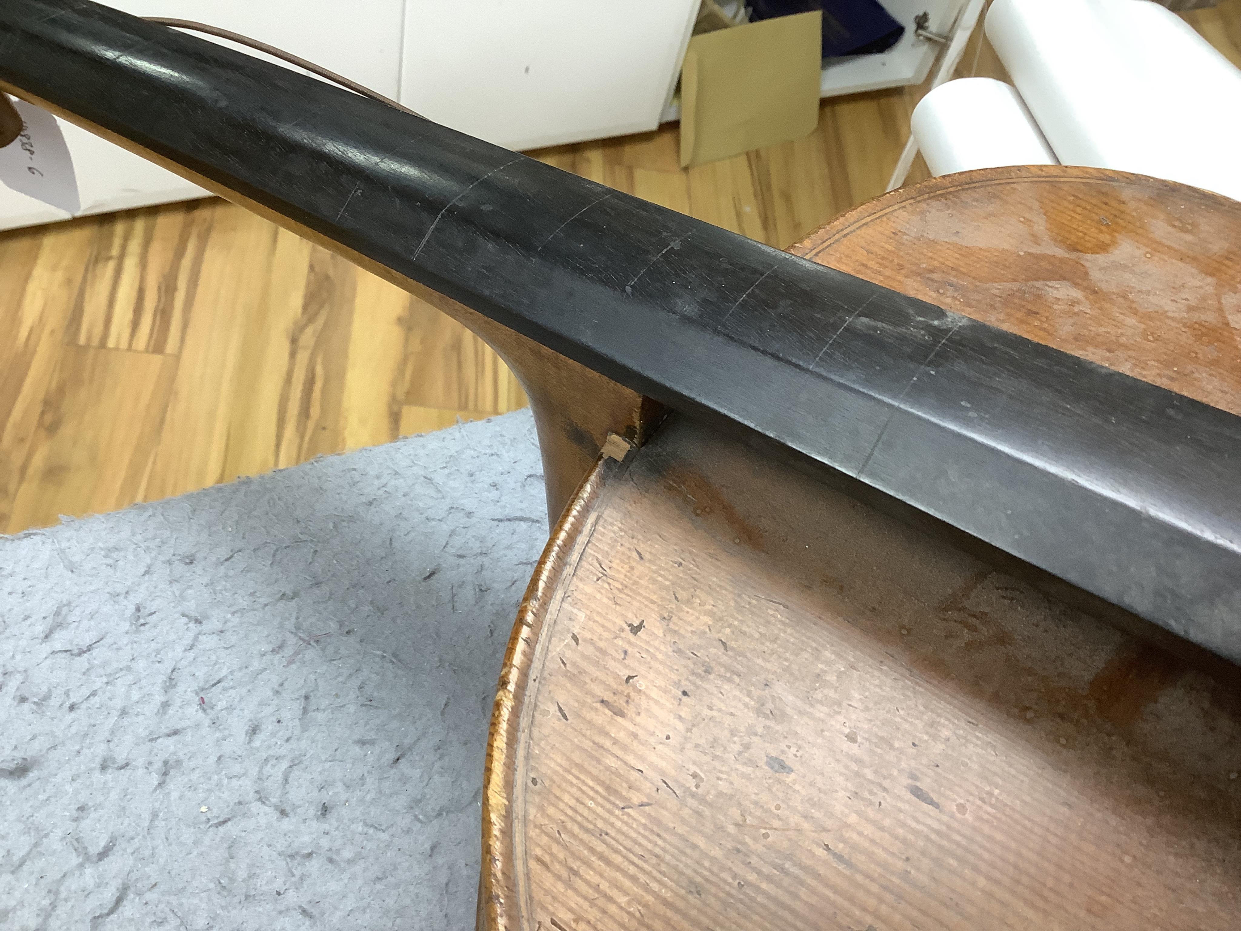 A late 19th century small cello, unsigned and without label inside body, stamped inventory number 769, length of back 62cm. Condition - poor to fair
